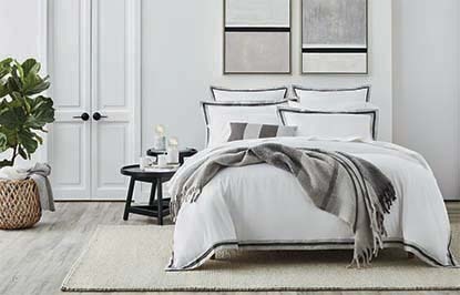 A white bedroom with gray-accented bedding