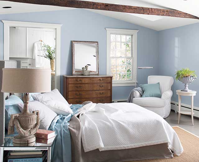 A bedroom with walls painted in Instinct AF-575, displaying the impact of cool paint colours.
