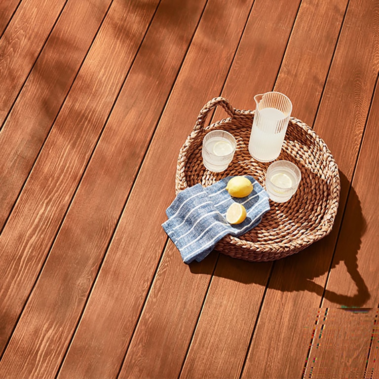 A deck stained with Mahogany ES-60 Semi-Transparent Woodluxe® Exterior Stain.