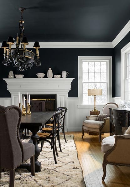Large dining room with dramatic black walls, ceiling, and white trim.