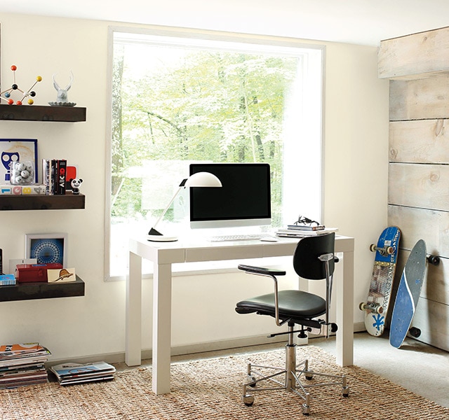 Home office painted in white with wood accent wall.