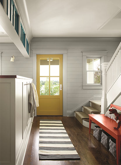 Entryway with yellow painted door and high-gloss finish