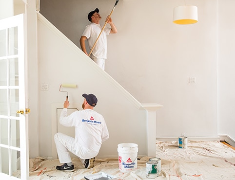 Painting Contractors work together in a home using Benjamin Moore paints